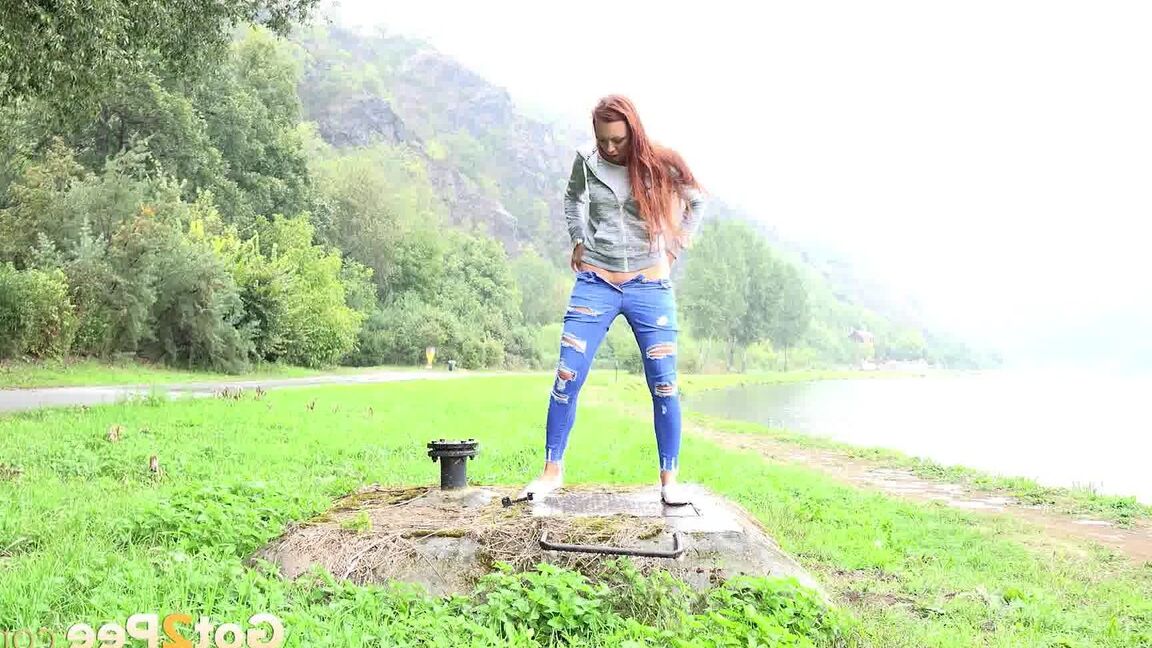 15P Redhead babe squats to pee outside by lake