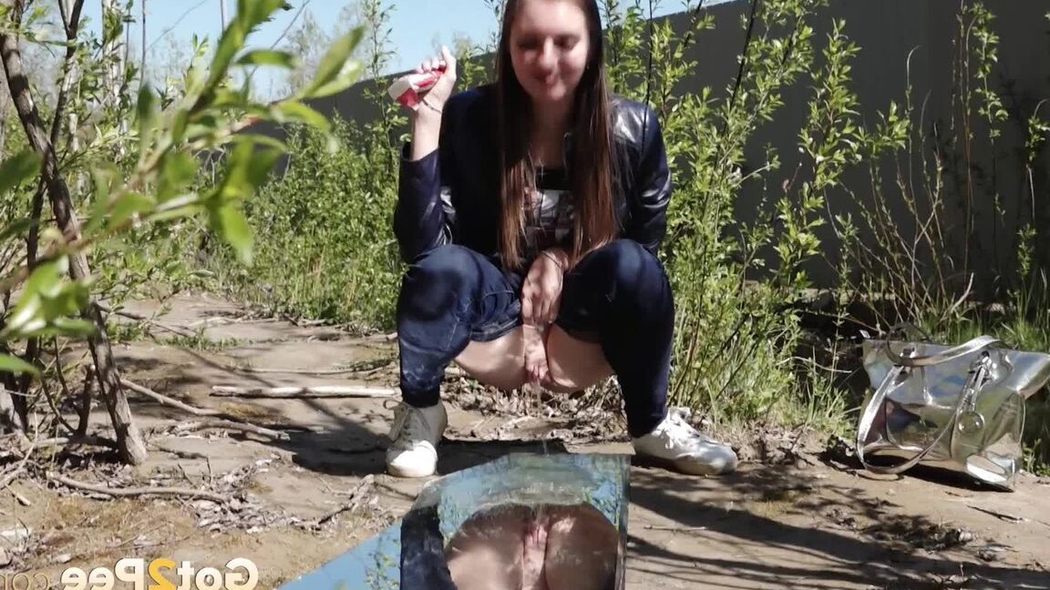 15P Distressed female Viktoria takes a badly needed piss on a mirror amid bushes