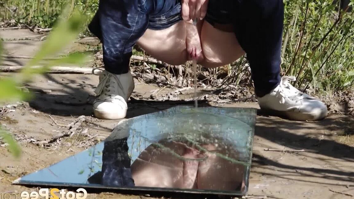 15P Distressed female Viktoria takes a badly needed piss on a mirror amid bushes