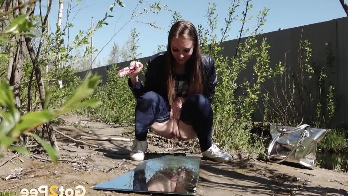 15P Distressed female Viktoria takes a badly needed piss on a mirror amid bushes