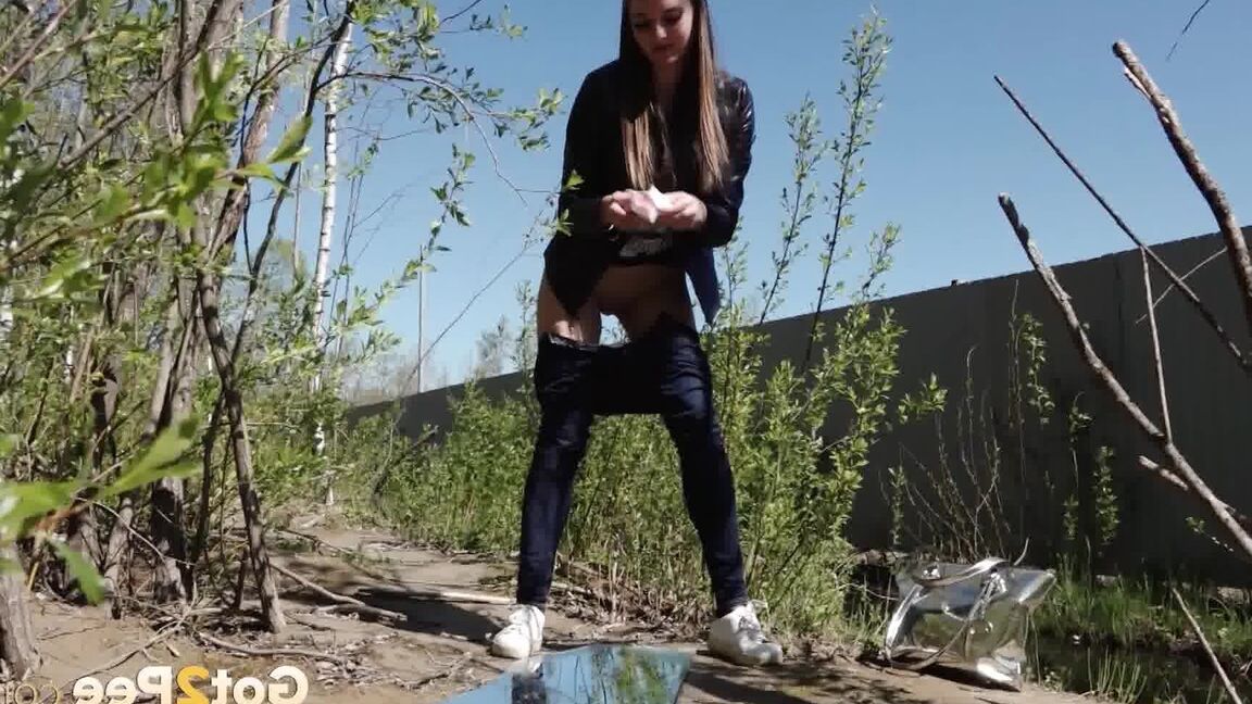 15P Distressed female Viktoria takes a badly needed piss on a mirror amid bushes