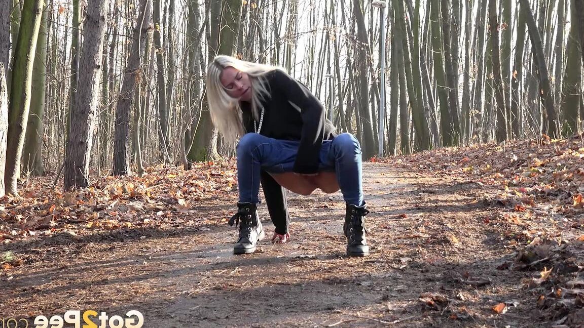 15P Blonde chick Claudia Macc pyulls down jeans for a pee on path in the forest