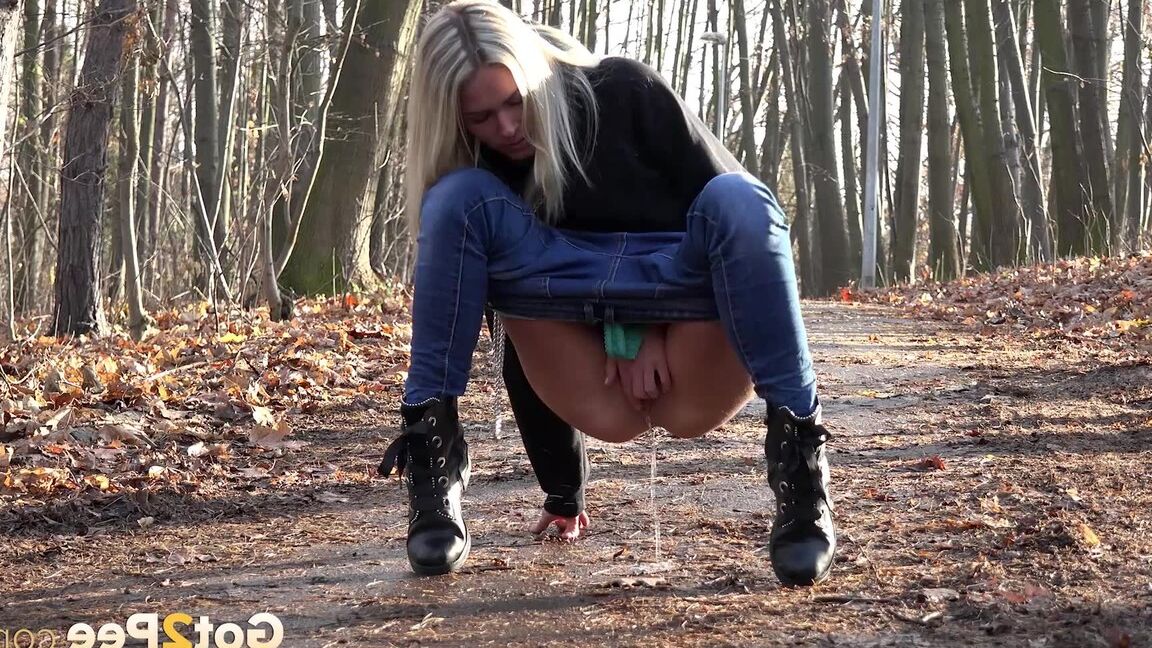15P Blonde chick Claudia Macc pyulls down jeans for a pee on path in the forest