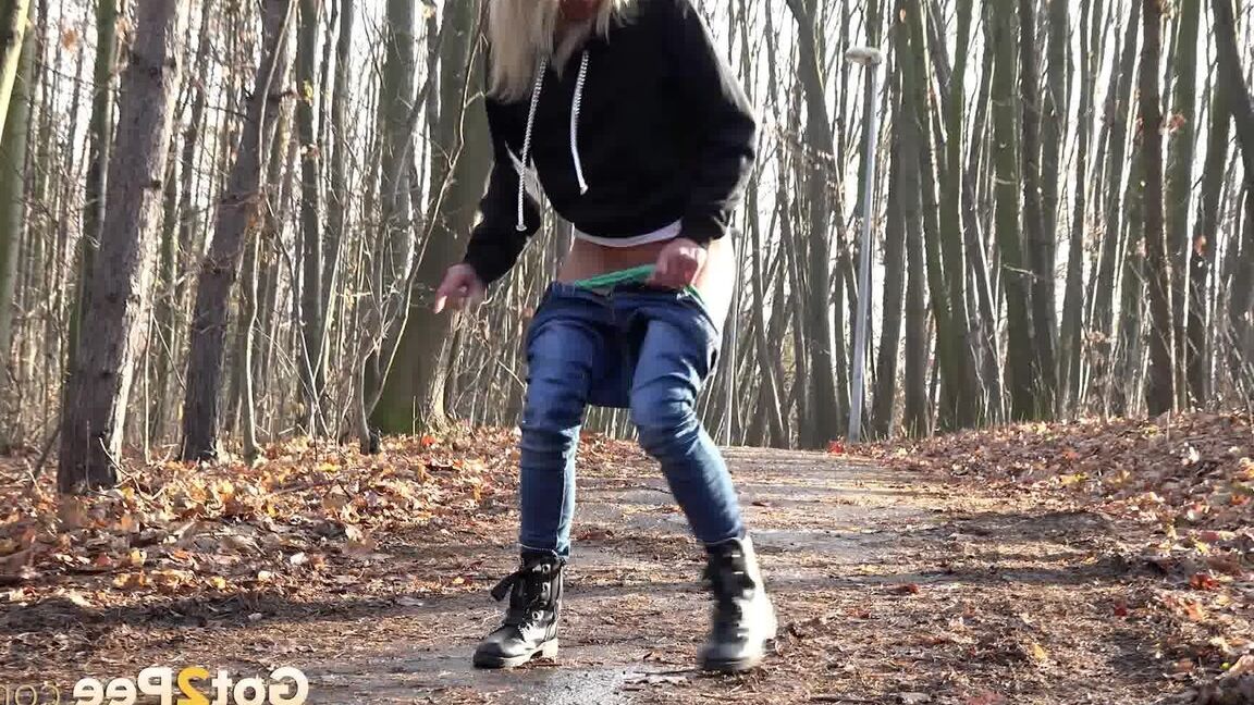 15P Blonde chick Claudia Macc pyulls down jeans for a pee on path in the forest