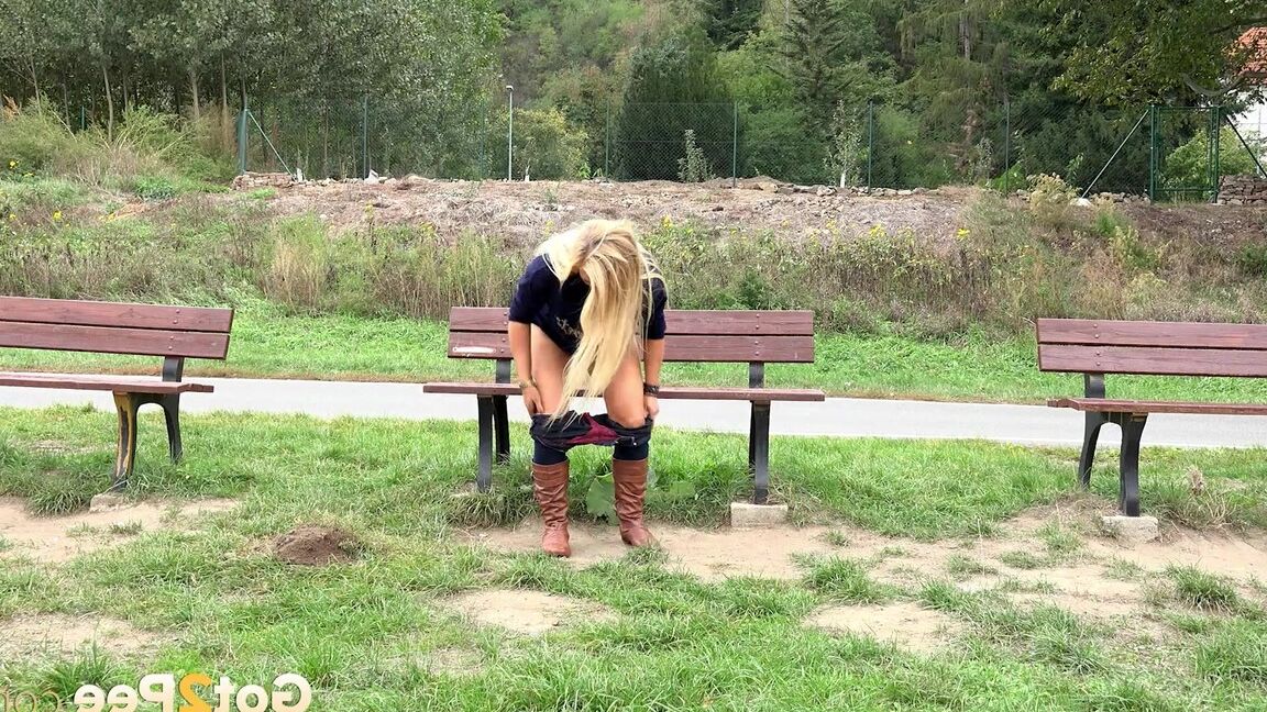 15P Thick blond chick Jenna Lovely squats for a piss next to bench beside the road