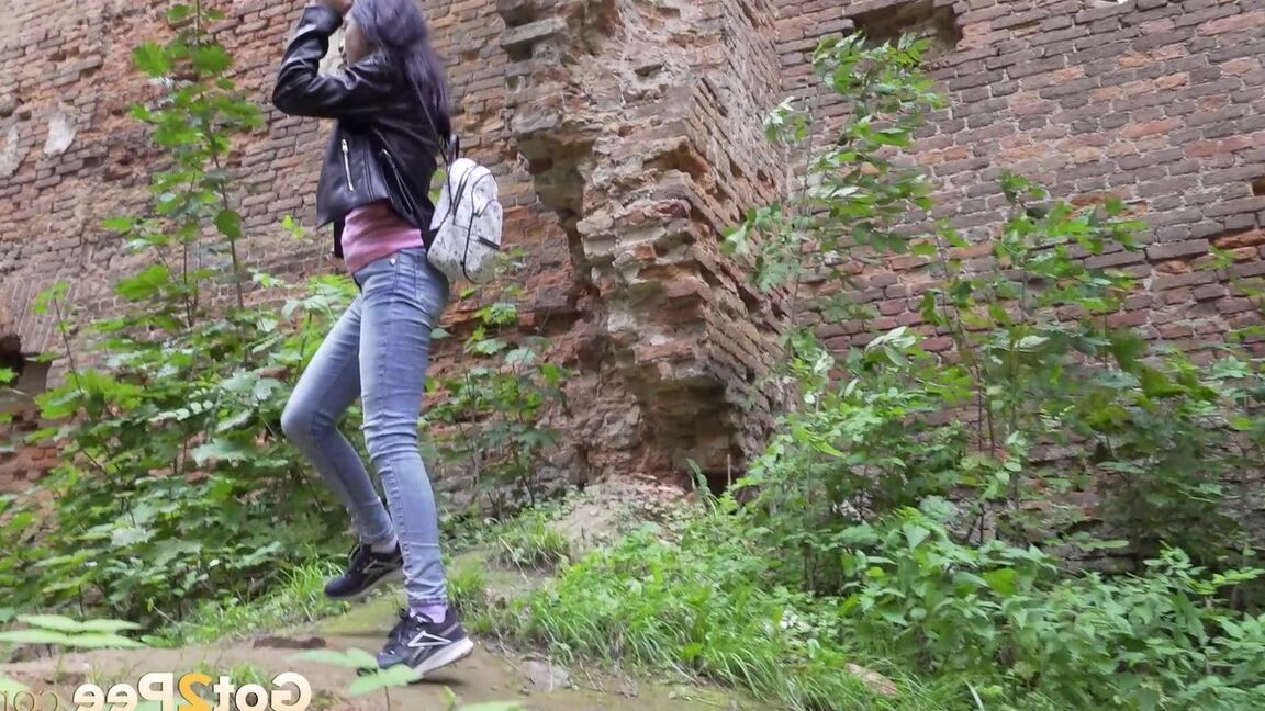 15P Dark-haired teen Natasha pulls down her jeans to pee on a patch of ground