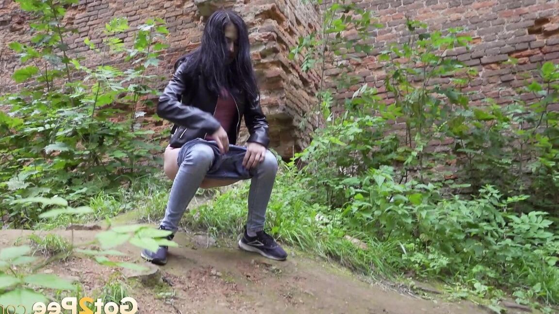 15P Dark-haired teen Natasha pulls down her jeans to pee on a patch of ground