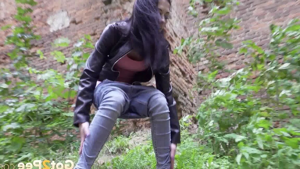 15P Dark-haired teen Natasha pulls down her jeans to pee on a patch of ground