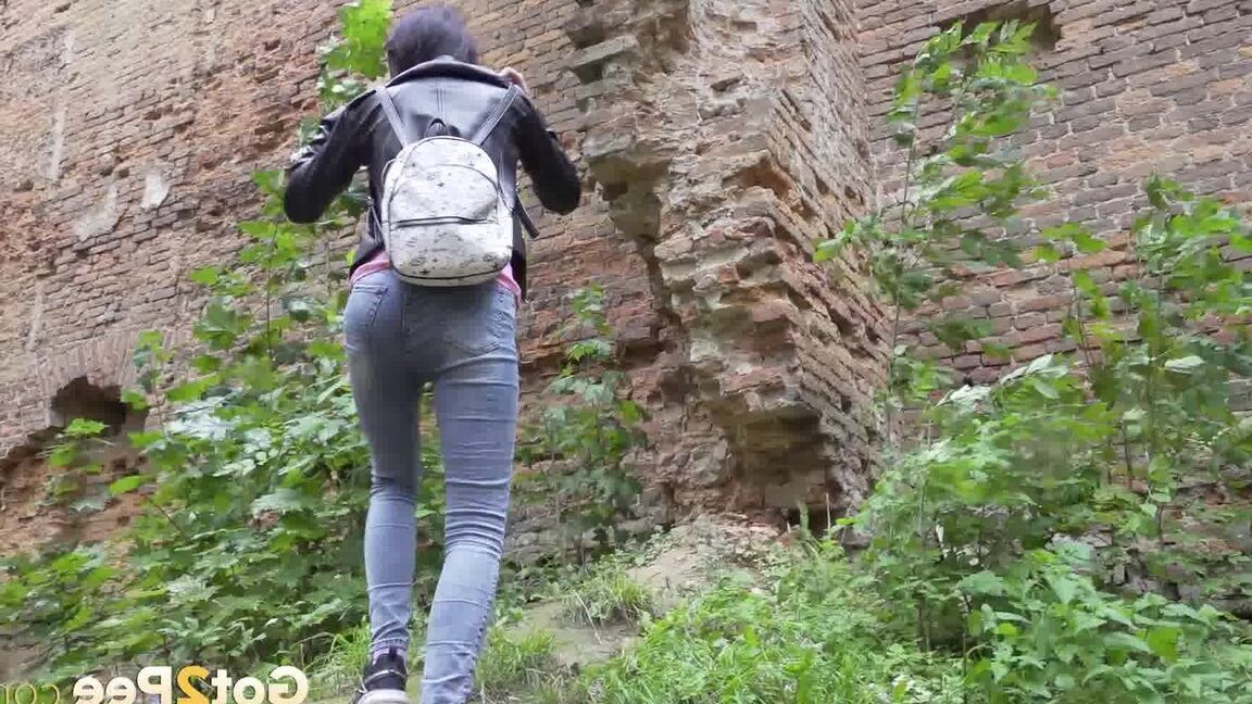 15P Dark-haired teen Natasha pulls down her jeans to pee on a patch of ground