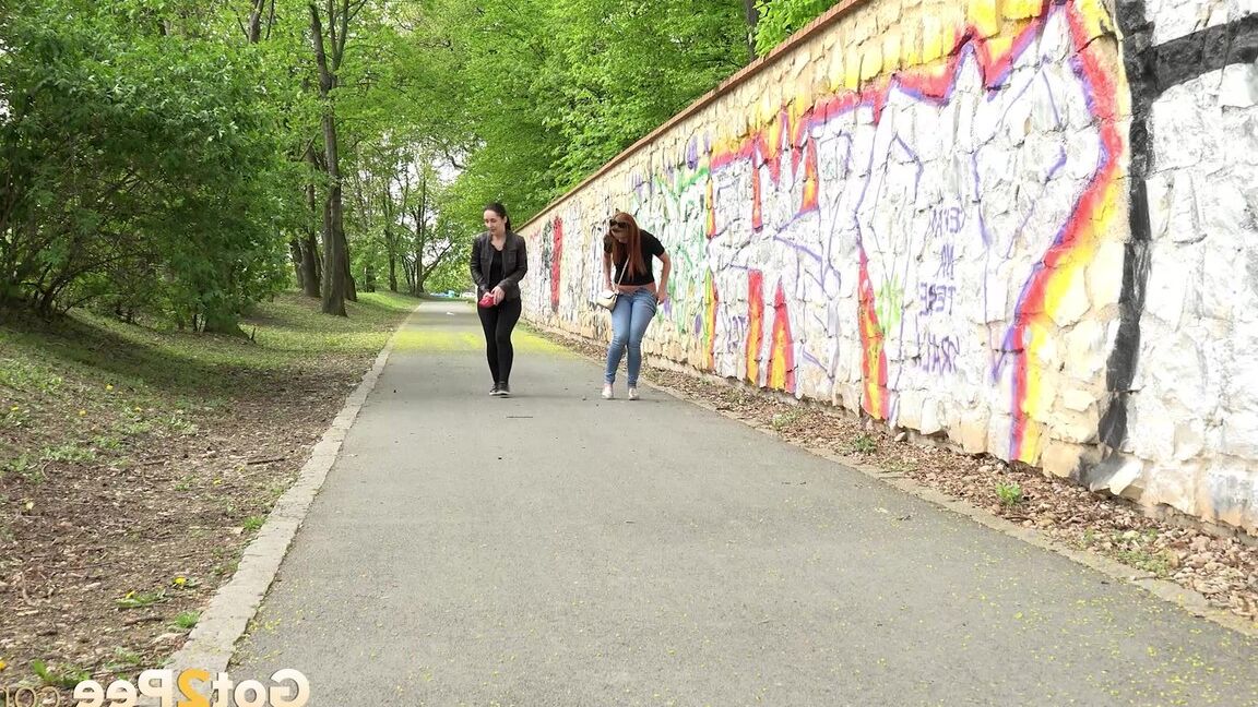 15P Two girls pull down their pants in order to piss on the road