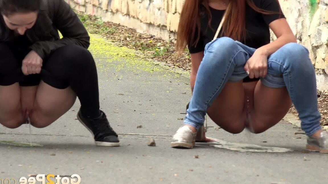 15P Two girls pull down their pants in order to piss on the road