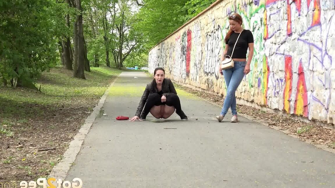 15P Two girls pull down their pants in order to piss on the road