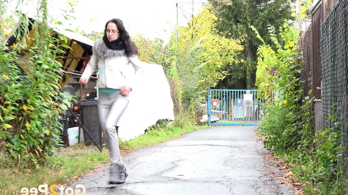 15P Clothed chick AngelAngel pulls down her pants for a piss on a public pathway