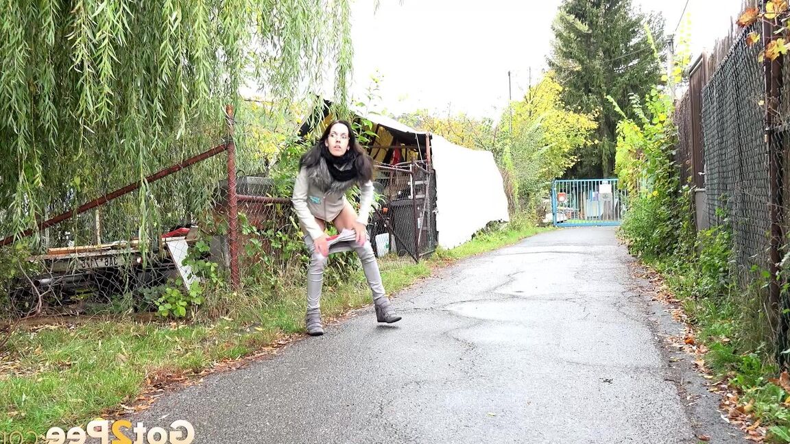 15P Clothed chick AngelAngel pulls down her pants for a piss on a public pathway