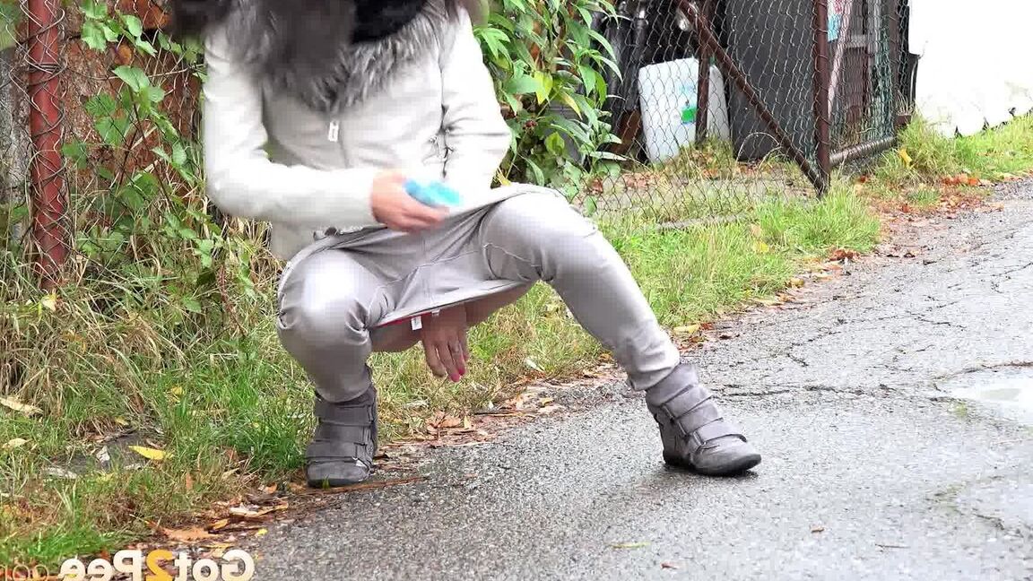 15P Clothed chick AngelAngel pulls down her pants for a piss on a public pathway