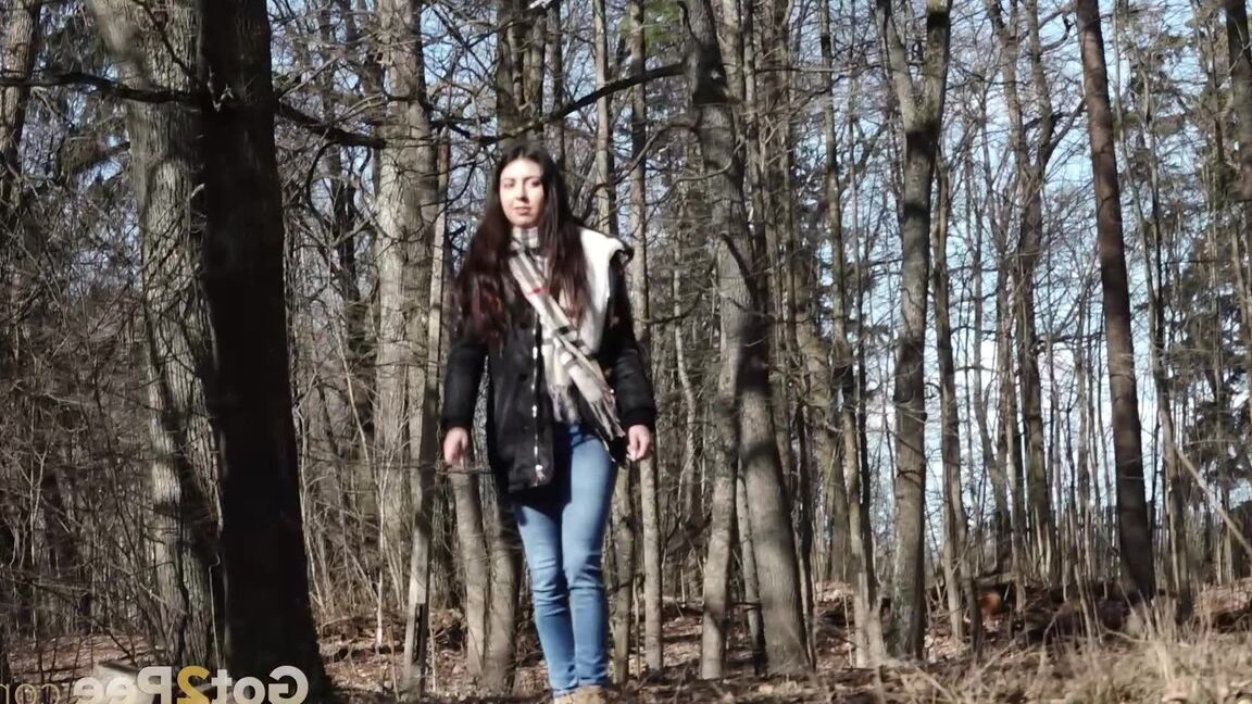 15P Clothed girl Katya pulls down her blue jeans to pee by an abandoned building