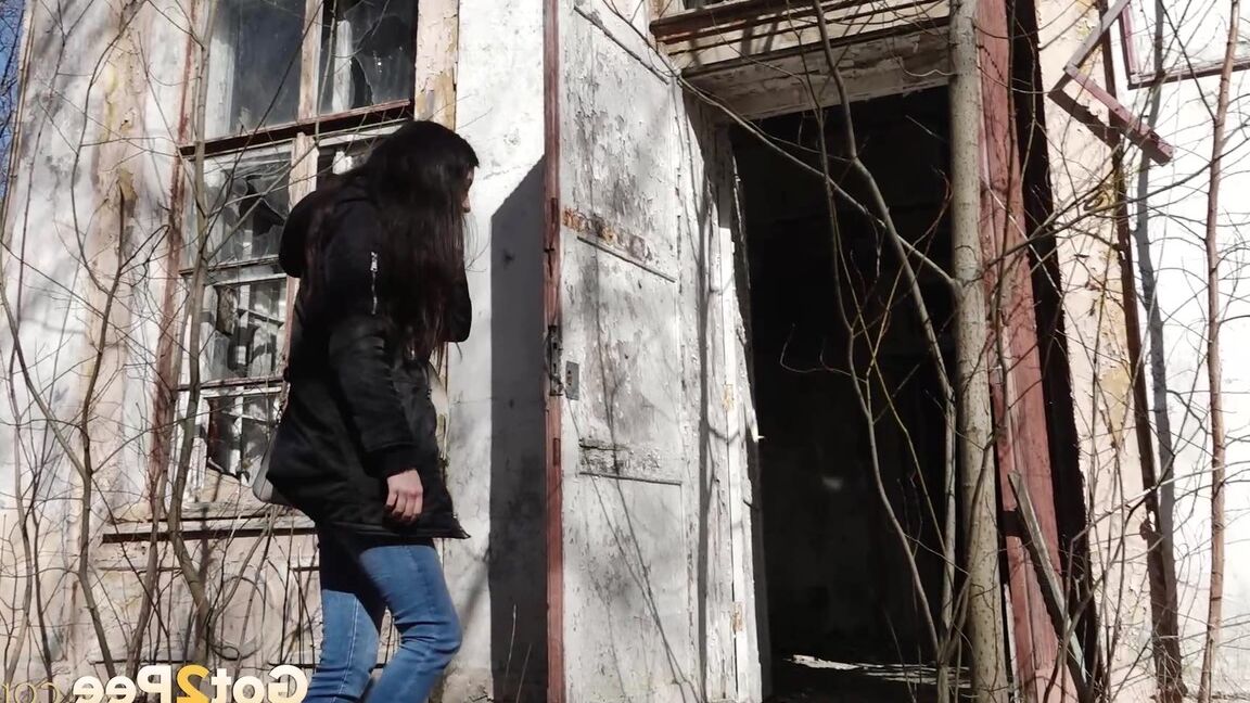 15P Clothed girl Katya pulls down her blue jeans to pee by an abandoned building