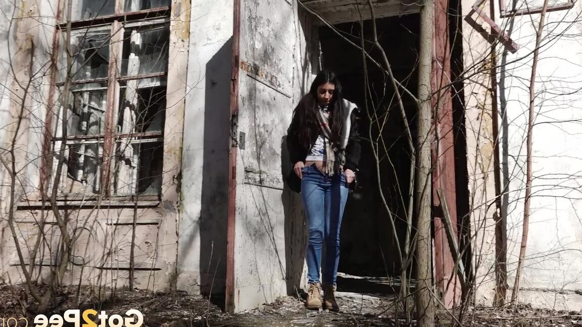15P Clothed girl Katya pulls down her blue jeans to pee by an abandoned building