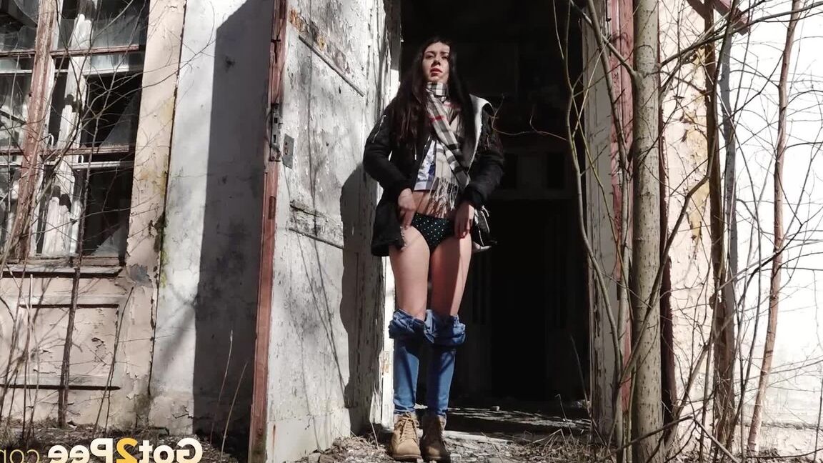 15P Clothed girl Katya pulls down her blue jeans to pee by an abandoned building