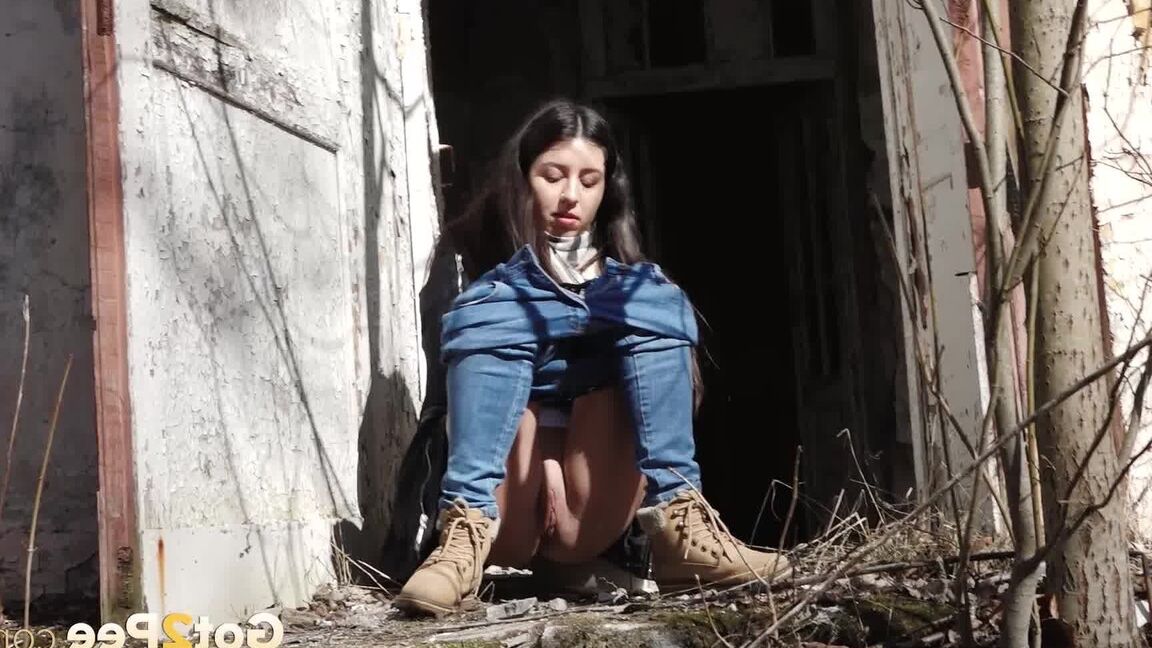 15P Clothed girl Katya pulls down her blue jeans to pee by an abandoned building