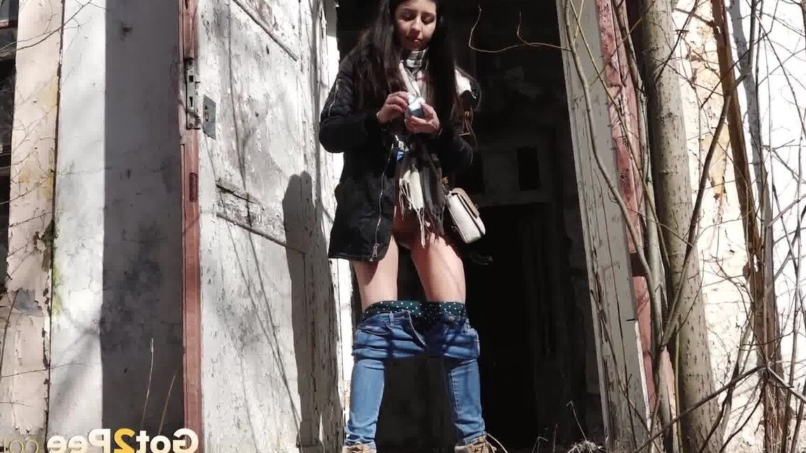15P Clothed girl Katya pulls down her blue jeans to pee by an abandoned building