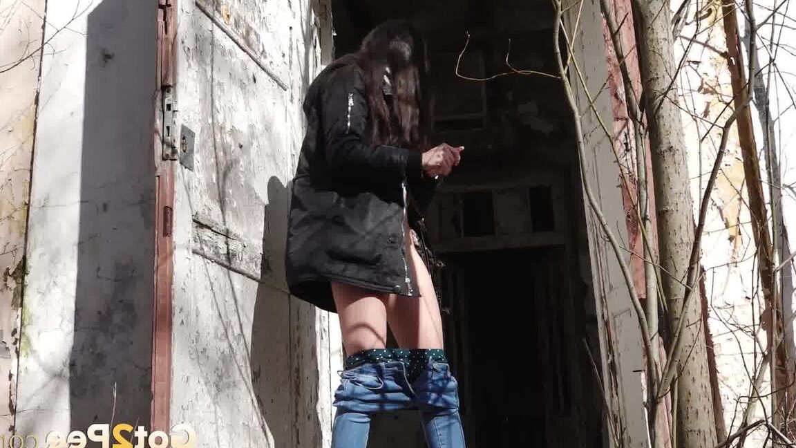 15P Clothed girl Katya pulls down her blue jeans to pee by an abandoned building
