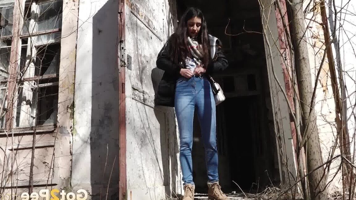 15P Clothed girl Katya pulls down her blue jeans to pee by an abandoned building