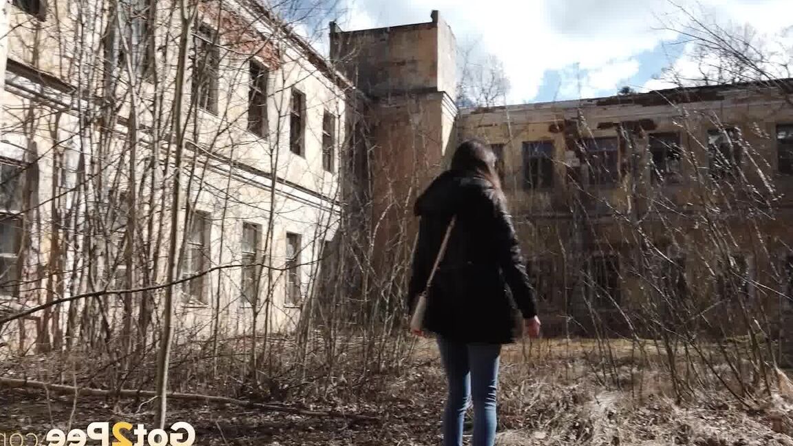 15P Clothed girl Katya pulls down her blue jeans to pee by an abandoned building