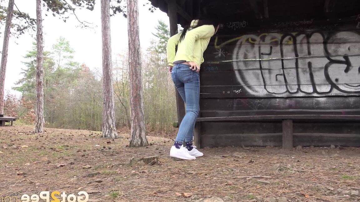 15P Tiny brunette Mistika squats for a piss next to a warming station in the woods