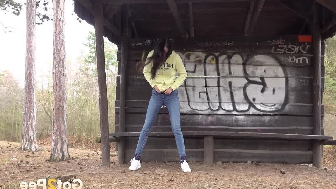 15P Tiny brunette Mistika squats for a piss next to a warming station in the woods