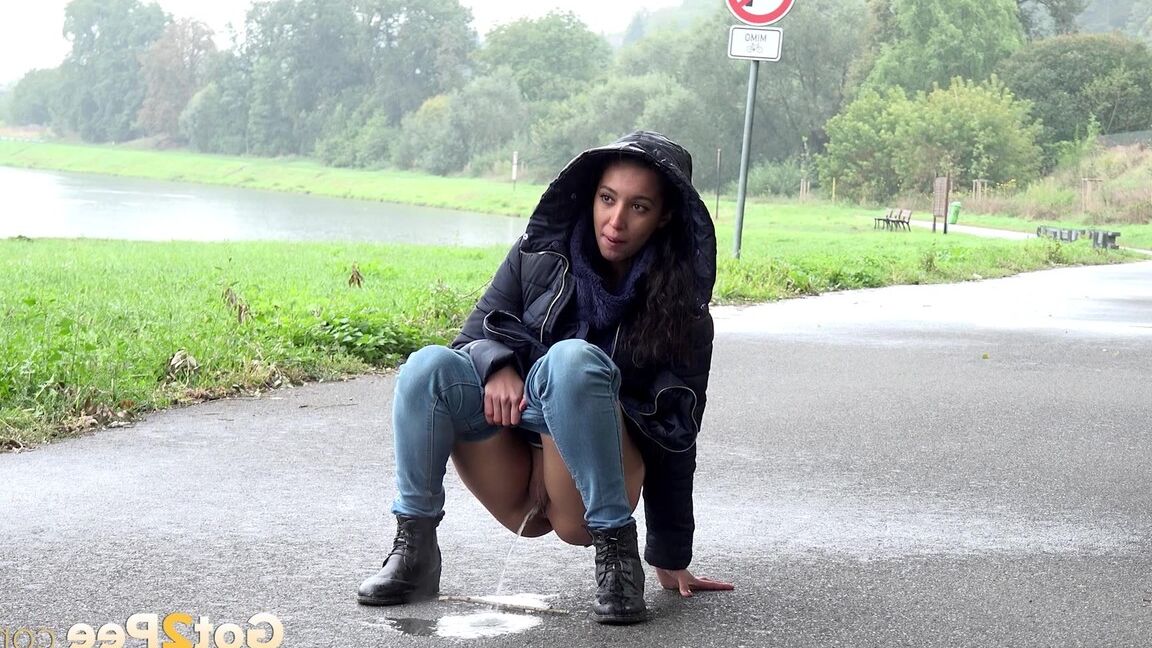 15P Gorgeous dark haired babe pees on the ground