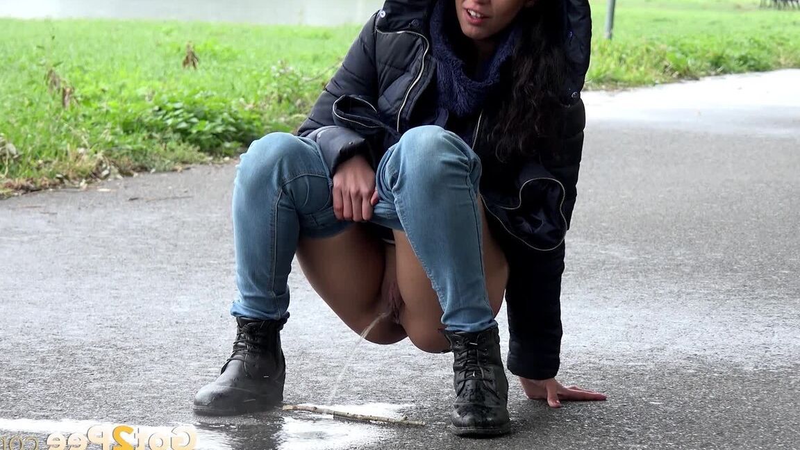 15P Gorgeous dark haired babe pees on the ground
