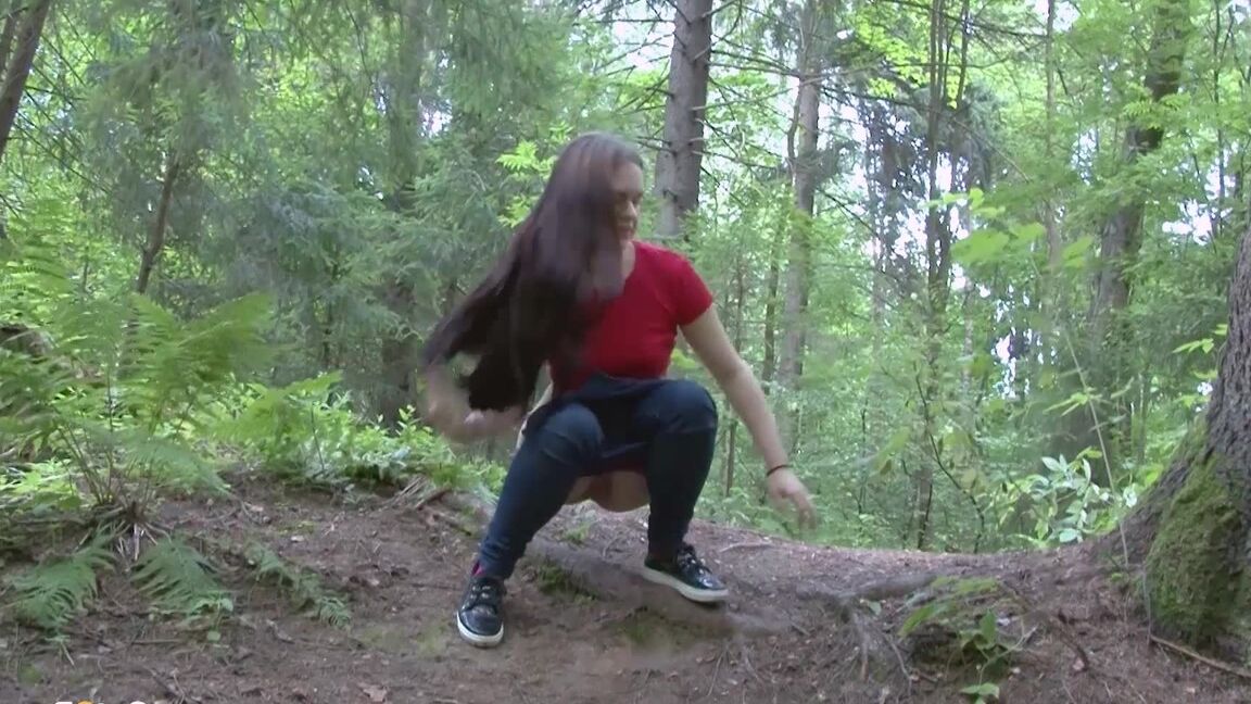 15P Long haired girl Lera pulls down her jeans for a piss on a bank in the woods