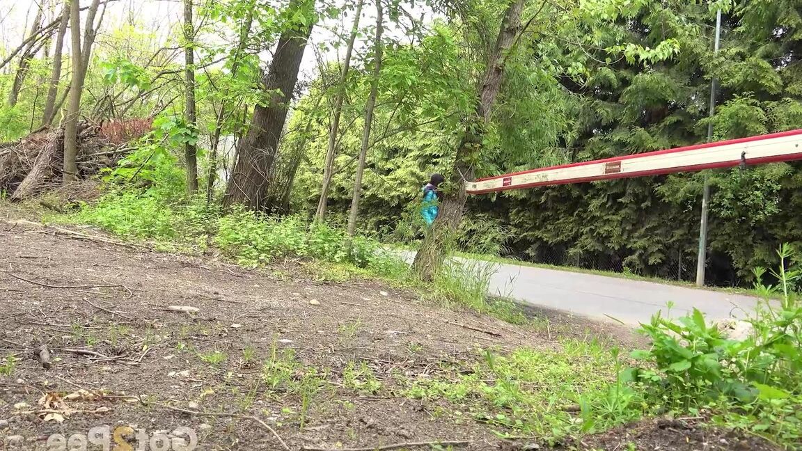 15P Short taken girl squats to be on a path in the woods while wearing a coat