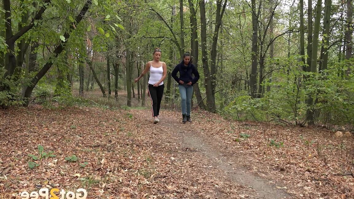 15P Two girls squat to relieve their bladders while taking a walk in the woods