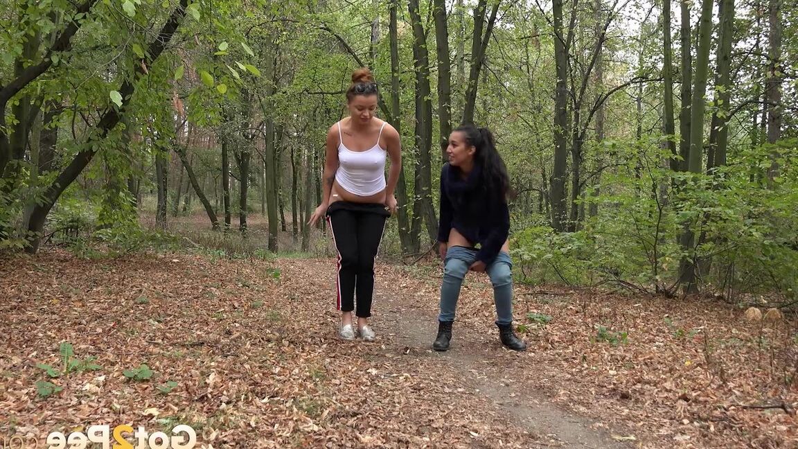 15P Two girls squat to relieve their bladders while taking a walk in the woods