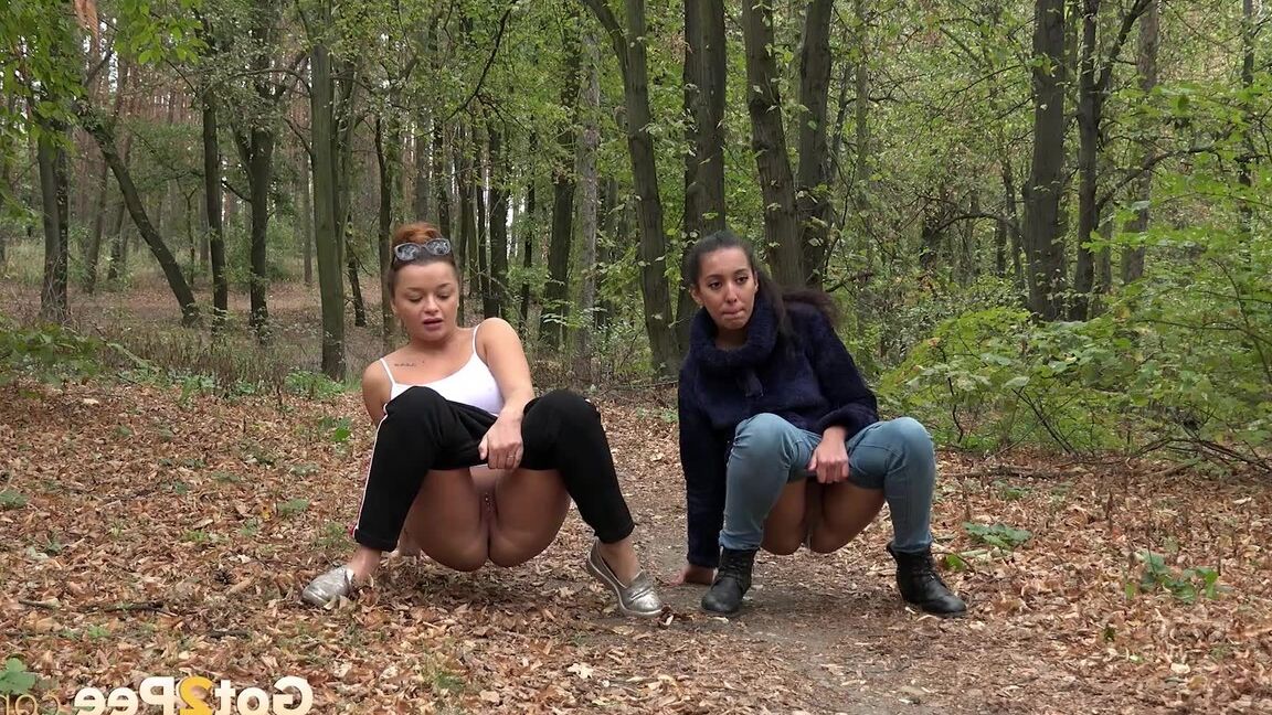 15P Two girls squat to relieve their bladders while taking a walk in the woods