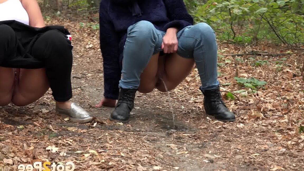 15P Two girls squat to relieve their bladders while taking a walk in the woods