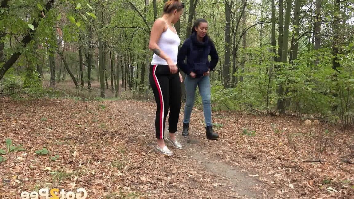 15P Two girls squat to relieve their bladders while taking a walk in the woods