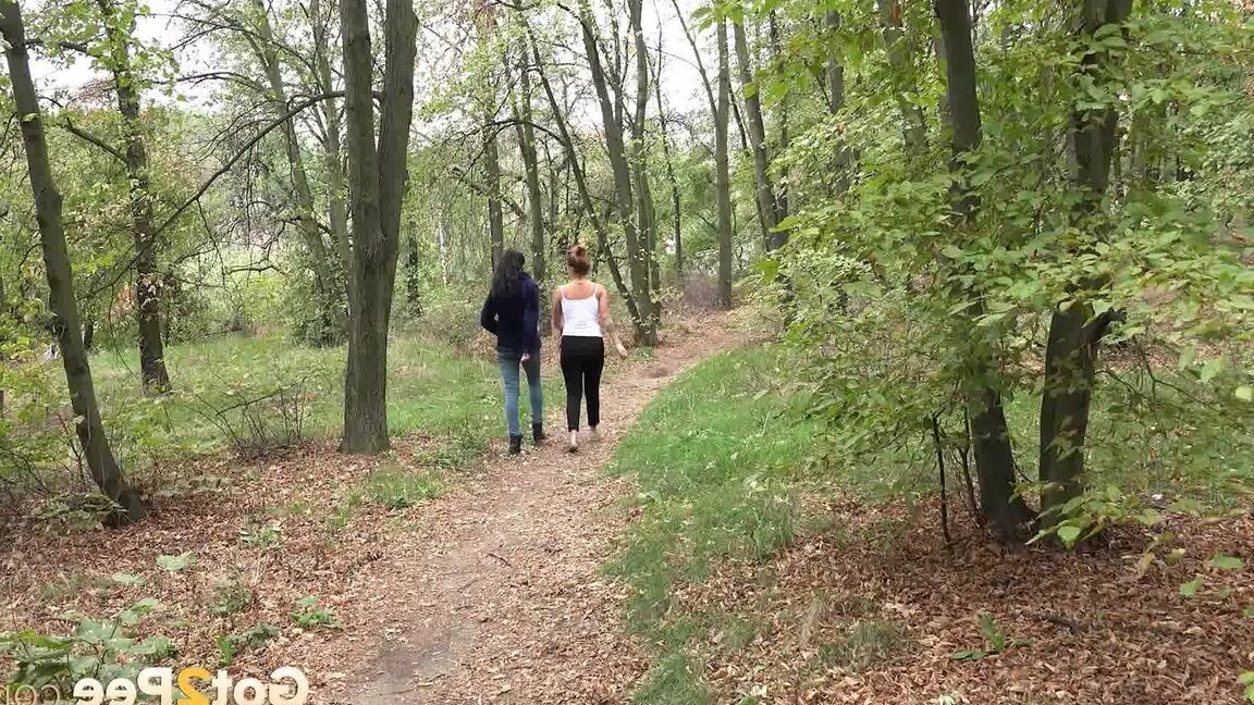 15P Two girls squat to relieve their bladders while taking a walk in the woods