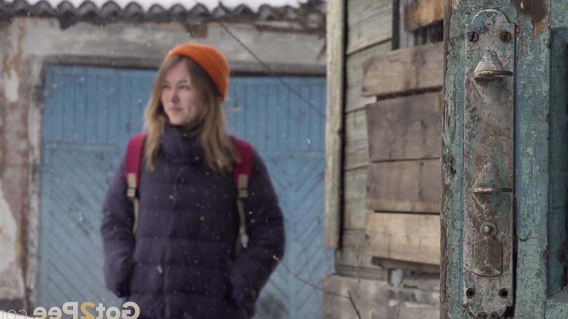 15P Cute girl pulls down jeans for an urgent piss on the steps of an old building