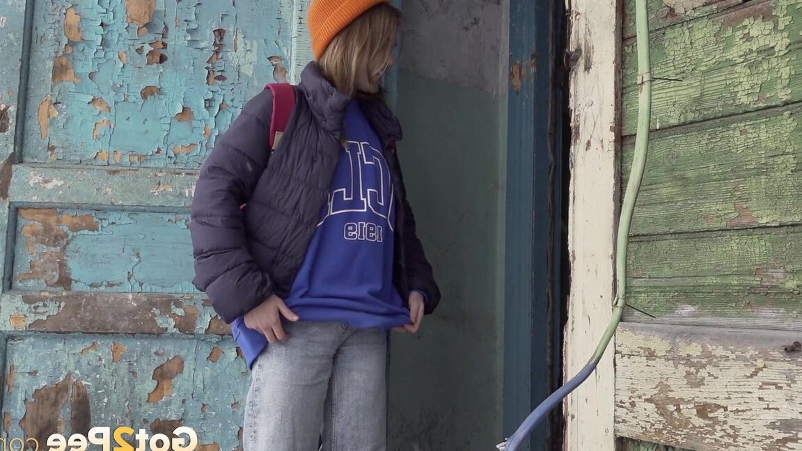 15P Cute girl pulls down jeans for an urgent piss on the steps of an old building