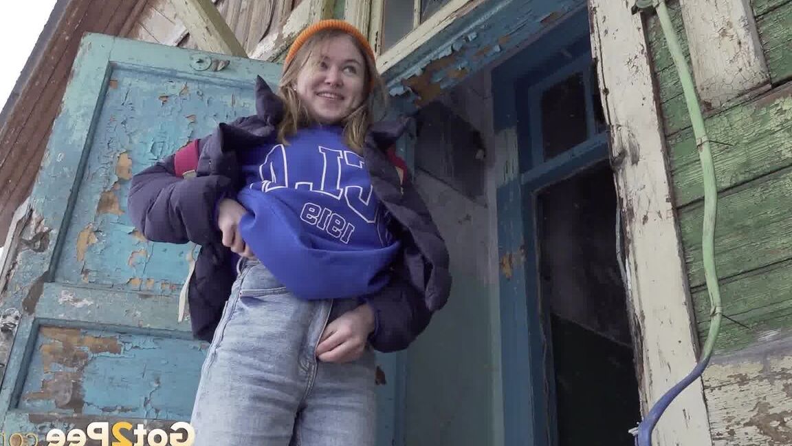 15P Cute girl pulls down jeans for an urgent piss on the steps of an old building
