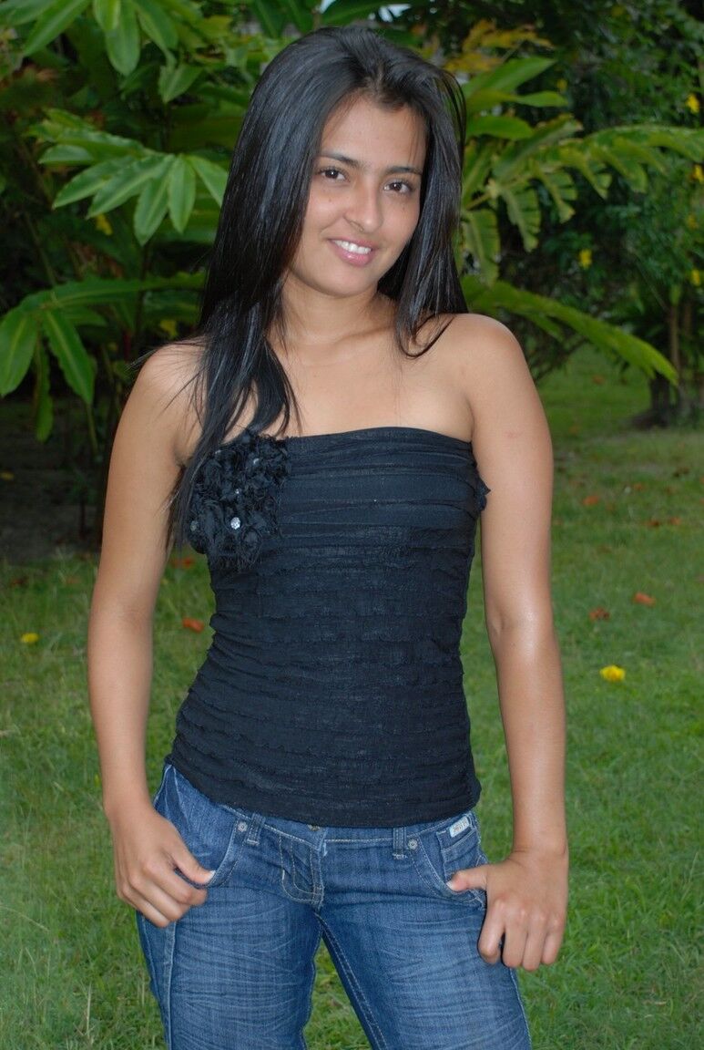 15P Hot black haired Jeniffer does a striptease on the lawn to finger her pussy