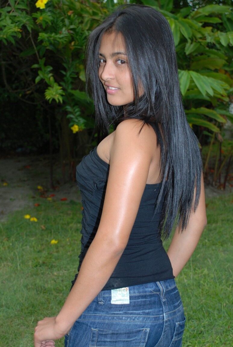 15P Hot black haired Jeniffer does a striptease on the lawn to finger her pussy