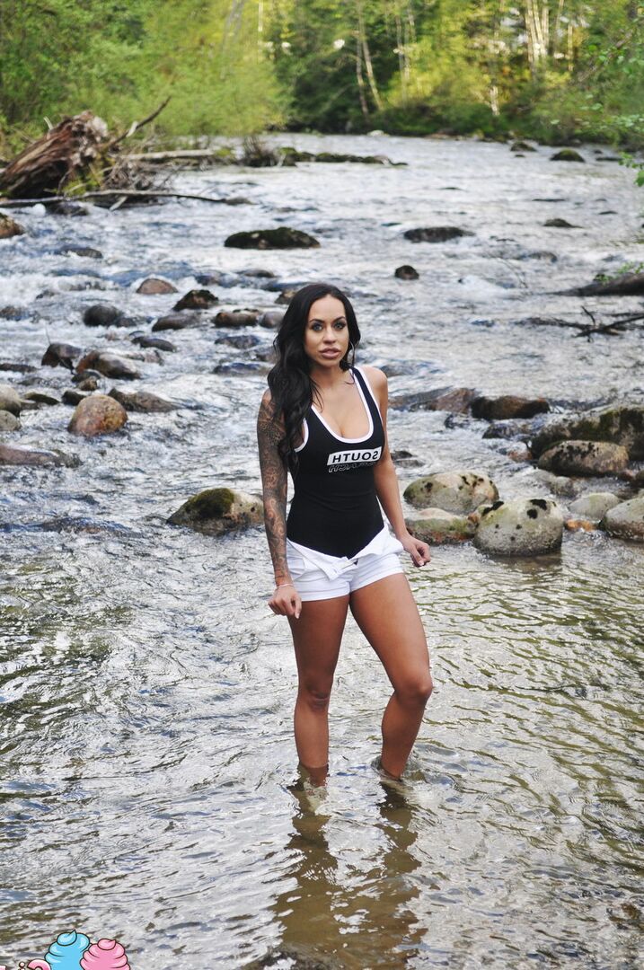 12P Latina teen Cindy Cupcakes pulls down her shorts while standing in a river