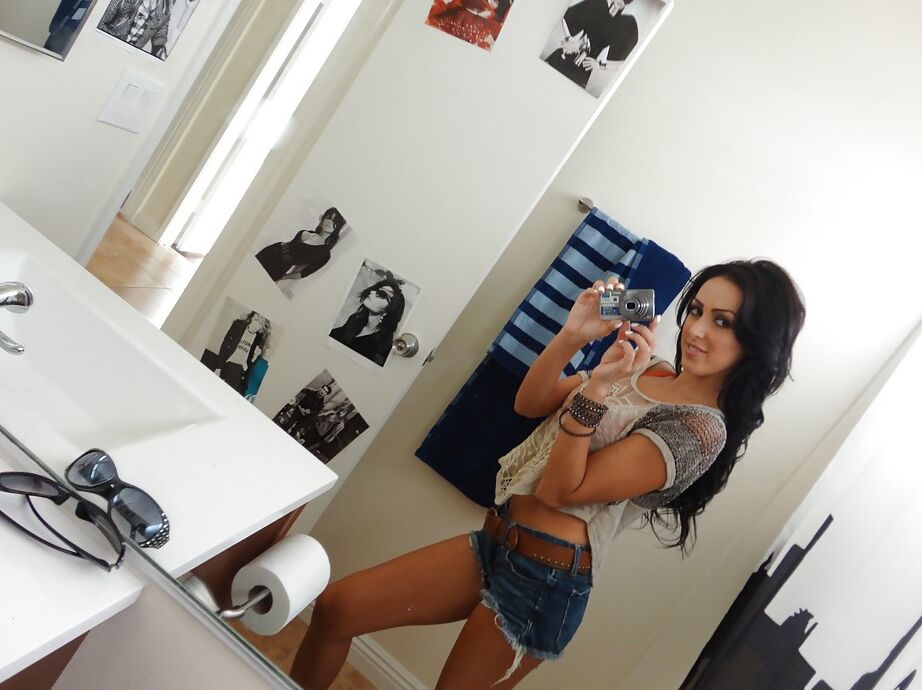 16P Brunette female Breanne Benson taking selfies in mirror while undressing