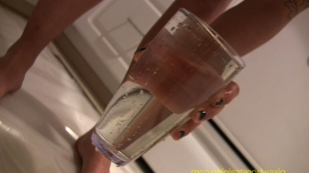 15P Rocker with tattoos fills a drinking glass with piss