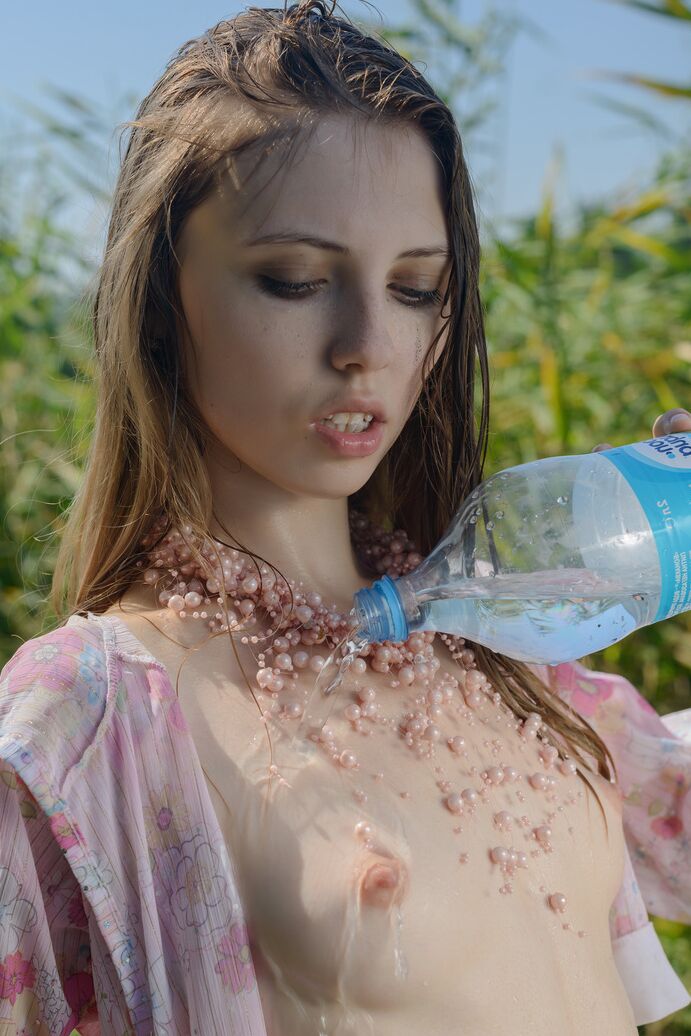 20P Thin teen Catalina douses her tiny tits & bald twat with water by weedy field