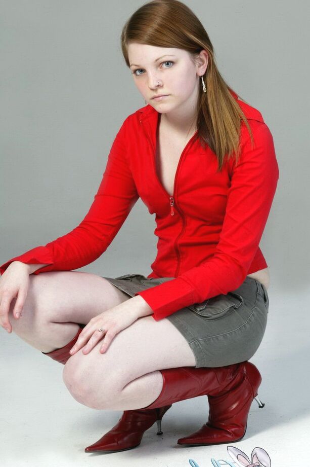 20P Pale redhead Lilly slowly strips to a black G-string and red leather boots